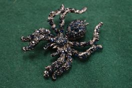 A gem encrusted black widow spider brooch.