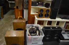 A pair of large floor standing speakers and three other pairs of speakers.