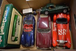 Cast metal model of an Aston Martin DB5 and other cars.