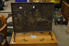 A brass fire guard and a box containing a large bottle carrier.