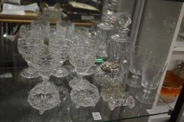 Five cut glass wine glasses, small decanter and other glassware.
