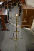 An adjustable brass music stand.