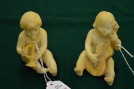 A pair of carved alabaster musical cherubs.