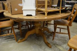 A pine circular pedestal table.