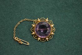 A gold amethyst and seed pearl brooch.