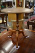 An inlaid mahogany tripod table.