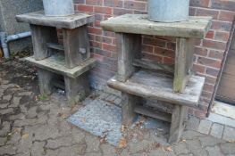 A set of four chunky wooden garden tables or stools.