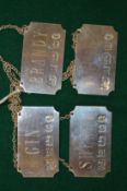A set of four silver decanter labels.