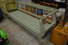 A large green painted bench.