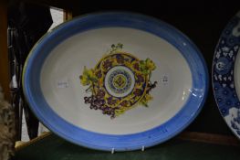 Four large decorative dishes to include an oval serving dish, circular Chinese blue and white