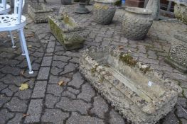 A pair of reconstituted stone garden troughs and a similar trough.
