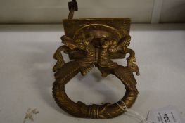 An Eastern bronze door knocker or handle in the form of entwined dragons.