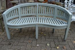 A pale green painted garden bench.