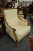A French beech wood framed cream upholstered armchair.