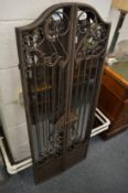 A wrought iron folding mirror.