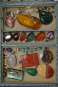 A collection of decorative silver and other pendants.