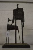 A modernist resin sculpture of a man and dog.