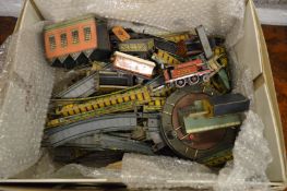 An early 20th century tin plated train with a track and accessories.