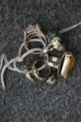 A collection of five decorative silver rings.