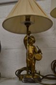 A pair of gilt bronze cherub table lamps.