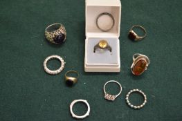A collection of gold and silver rings.