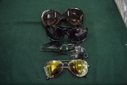Four pairs of sunglasses.