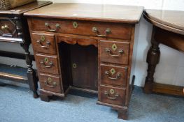 A George III mahogany kneehole desk of small size.