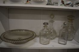 Four cut glass decanters and a cut glass bowl.