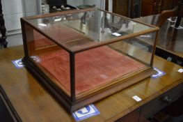 A mahogany table top display cabinet.