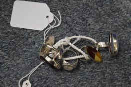 A collection of five decorative silver rings.