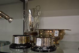A decorative plated bowl, a trophy and two trophy stands.