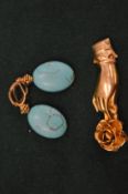 A silver gilt brooch modelled as a hand holding a rose together with a pair of earrings.