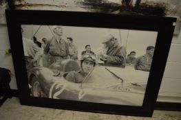 A large photographic print of the racing driver Luigi Musso seated in a Ferrari, image size 145cm