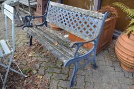 A cast metal and wooden garden bench.
