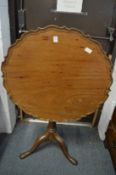 A George III mahogany piecrust tilt-top tripod table.