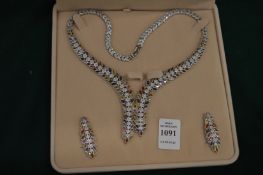 A decorative multi-coloured gem set necklace and matching pair of earrings.