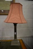 A plated corinthian column style table lamp.