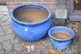 Two blue glazed terracotta planters.
