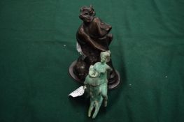 A bronze phallic being ridden by a women together with another similar resin version.