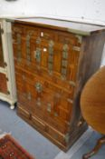 A Korean elm cabinet on base with numerous cupboard doors and drawers.