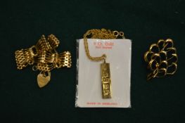 A 9ct gold ingot pendant with chain and padlock clasp and a brooch.
