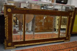 A George III mahogany and gilt wood three panel over-mantel mirror.