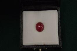 A natural cabochon oval ruby gemstone with certificate.