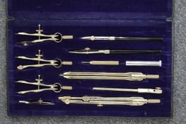 A cased drawing instrument set.