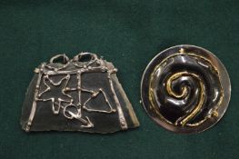 An African pendant and a brooch.
