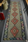 A Kelim runner, 300cm x 83cm.