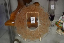 A pair of Lalique moulded and tinted glass circular plates decorated with leaves.