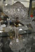 A cut glass table lamp and shade.