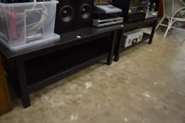 A pair of ebonised two-tier coffee tables.