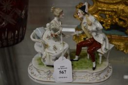 A Sitzendorf porcelain group of a seated gentleman and lady.